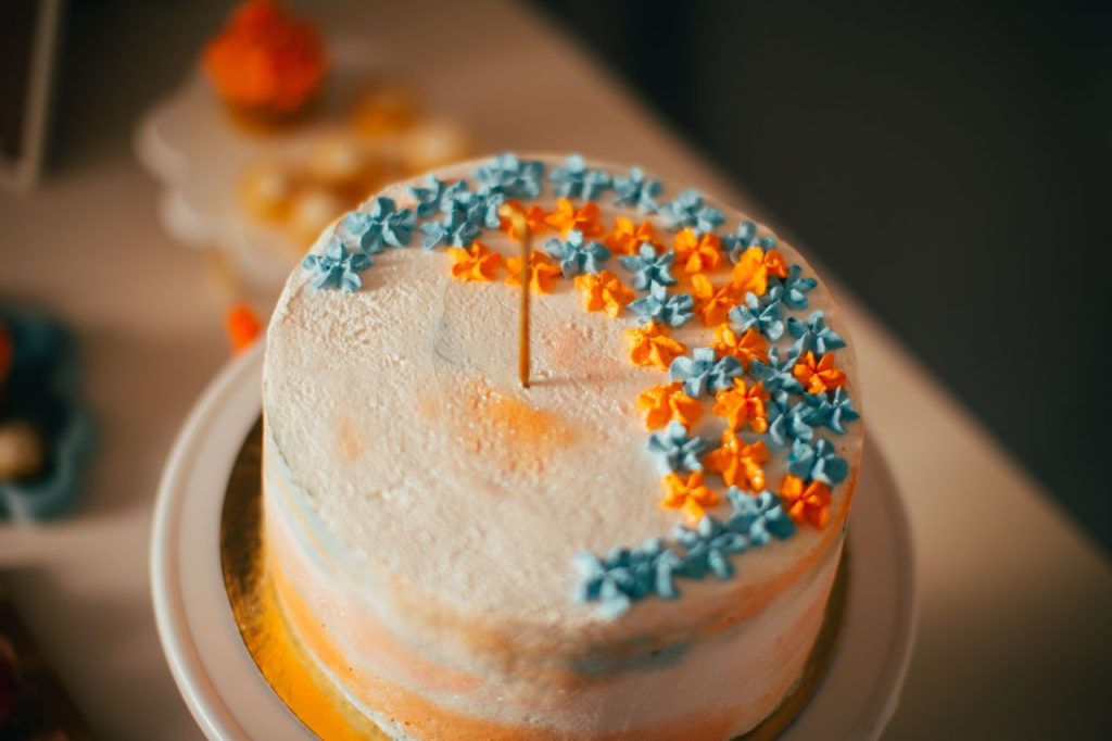Close-up of a decorated cake with colorful floral designs, perfect for celebrations.